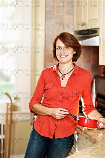 Woman in kitchen. Photo : Elena Elisseeva