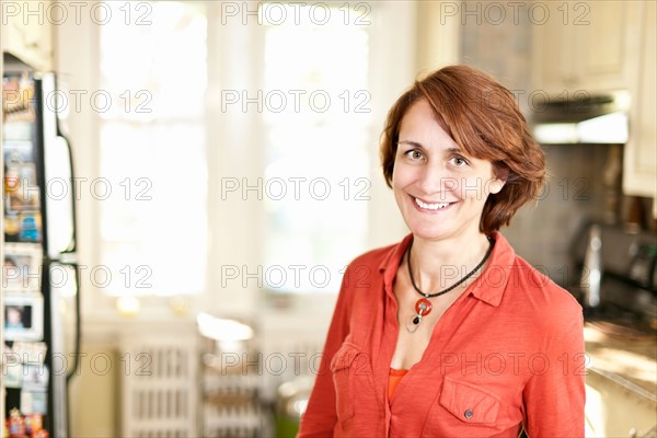 Woman in kitchen. Photo : Elena Elisseeva