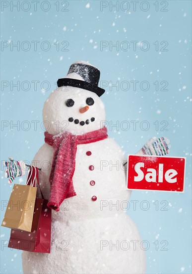 Studio shot of snowman with shoppings.