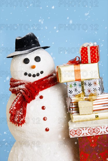 Studio shot of snowman with Christmas presents.