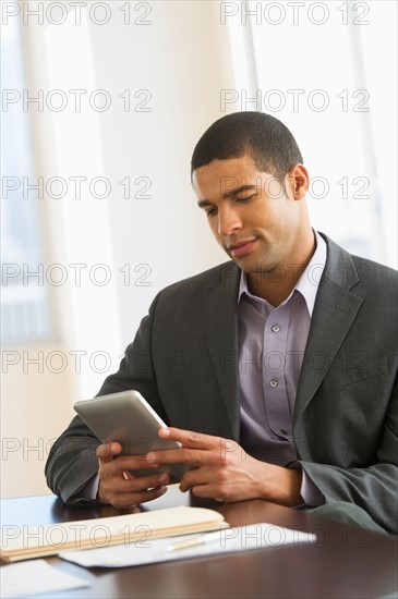 Businessman using tablet pc.