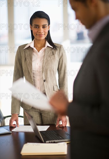 Business man and woman in office.