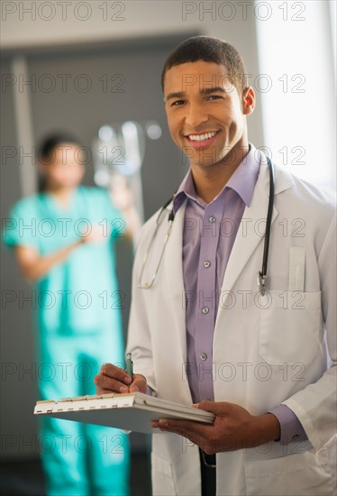 Portrait of male doctor in hallway.