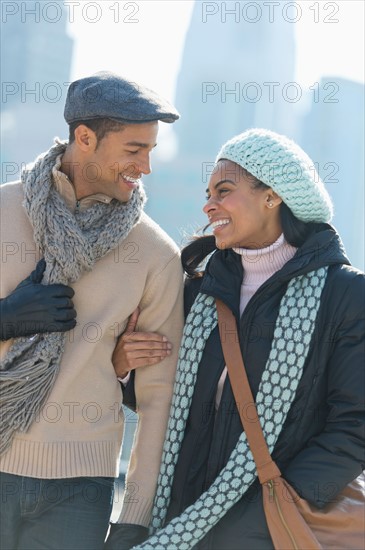 Couple walking in winter clothes.