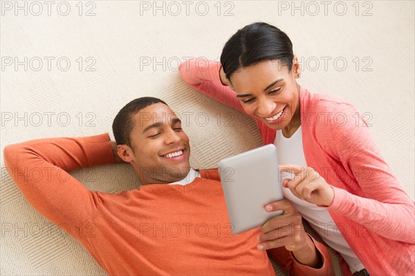 Couple reading e-book.