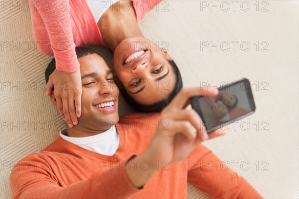 Couple taking photo with smartphone.