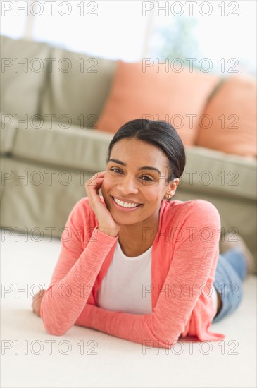 Portrait of woman lying on floor.