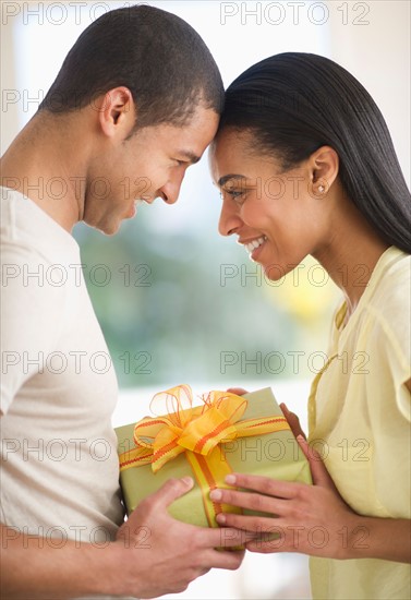 Couple holding gift box.