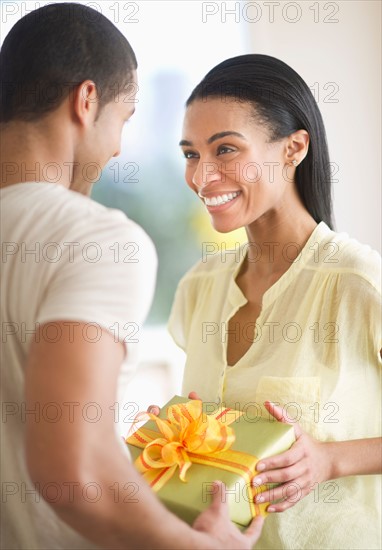 Couple holding gift box.