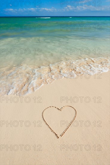 Mexico, Yucatan. Heart drawing in sand on beach.