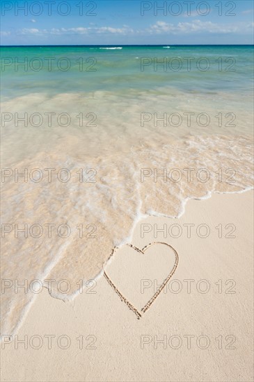 Mexico, Yucatan. Heart drawing in sand on beach.