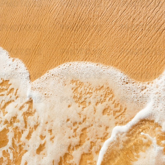 Mexico, Yucatan. Sea waves on beach sand.