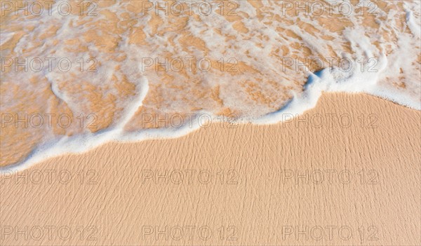 Mexico, Yucatan. Sea waves on beach sand.