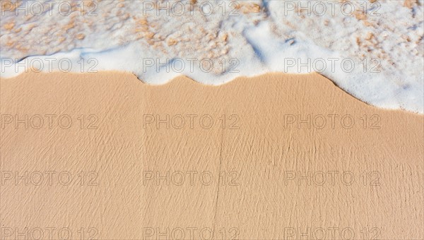 Mexico, Yucatan. Sea waves on beach sand.