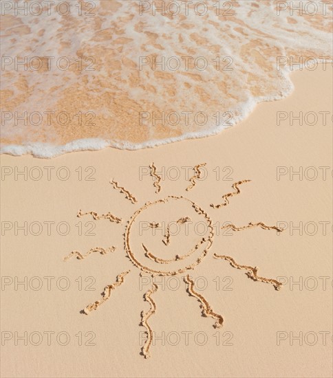 Mexico, Yucatan. Sun drawing on beach.
