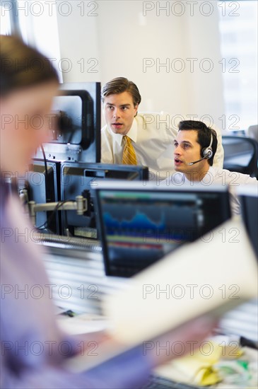 Traders at trading desk.