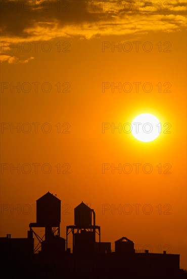 Silhouette of water tower at sunset.