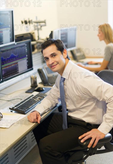 Portrait of trader at trading desk.