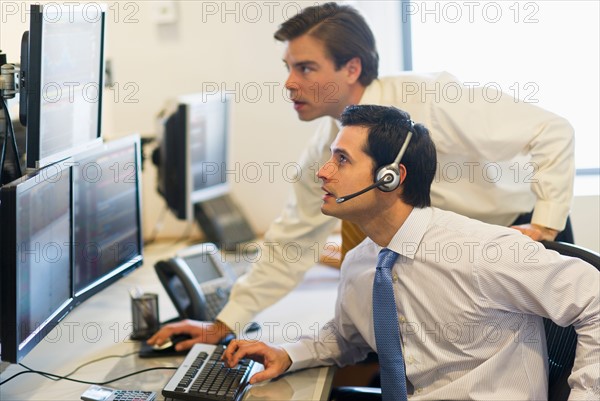 Traders at trading desk.