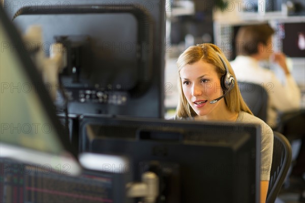 Female trader at trading desk.