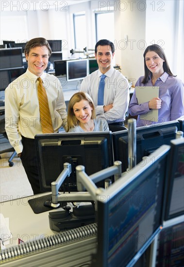 Portrait of traders at trading desk.