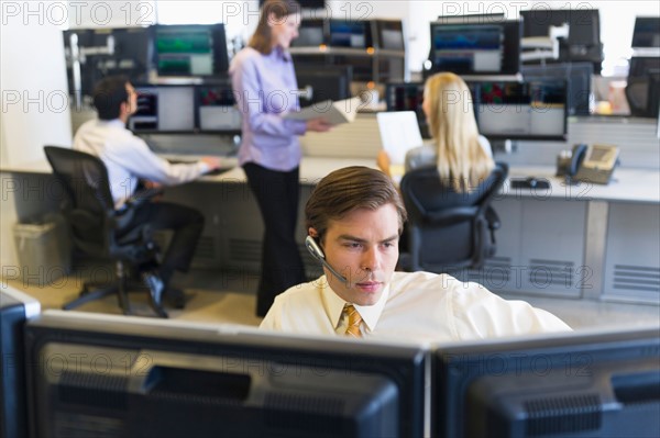 Traders at trading desk.