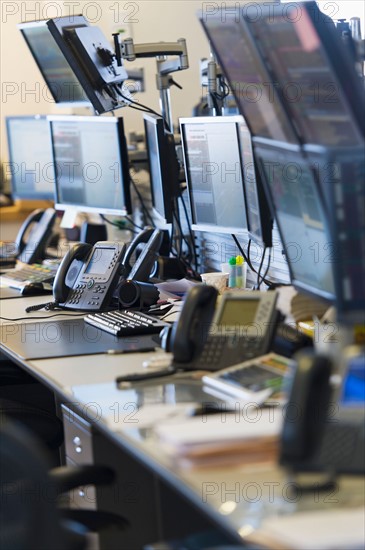 Trading desk with computers and phones.