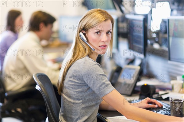 Portrait of female trader at trading desk.