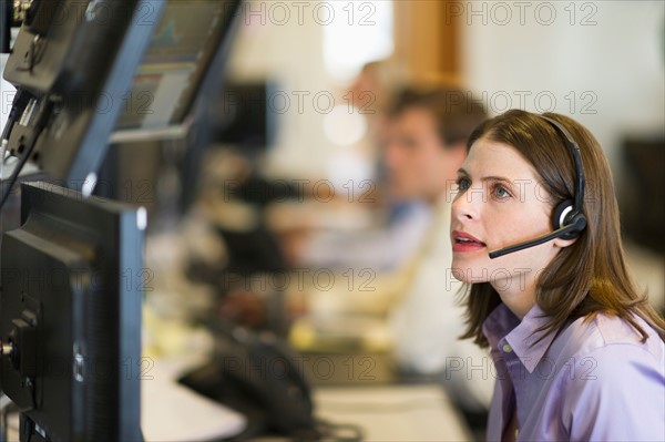 Female trader at trading desk.