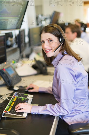Portrait of female trader at trading desk.