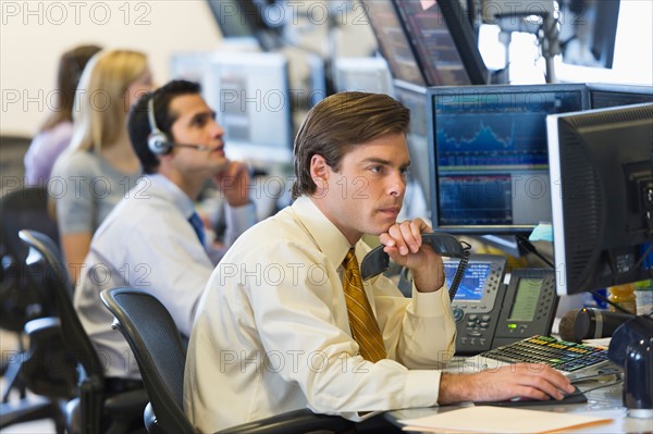 Traders at trading desk.