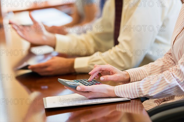 Hands of business people at business meeting.