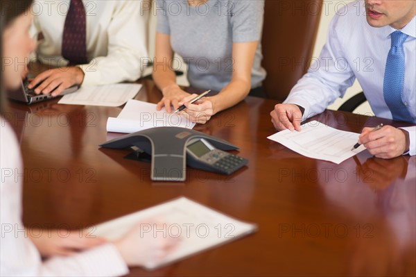 Hands of business people at business meeting.