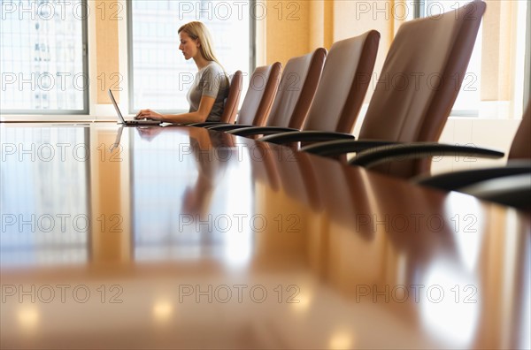 Businesswoman sitting in board room.