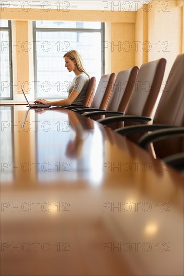 Businesswoman sitting in board room.