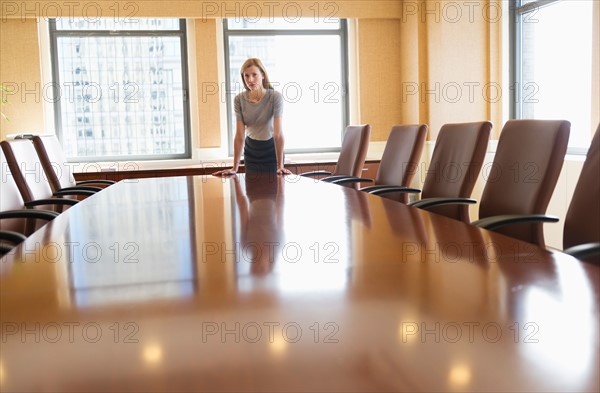 Businesswoman standing in board room.