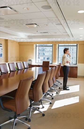 Businessman standing in board room.