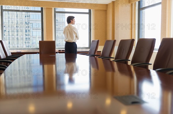 Businessman standing in board room.