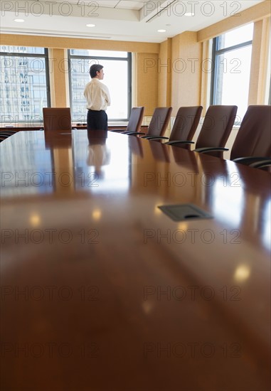 Businessman standing in board room.