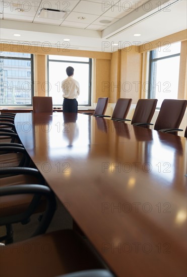 Businessman standing in board room.