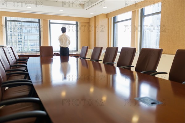 Businessman standing in board room.