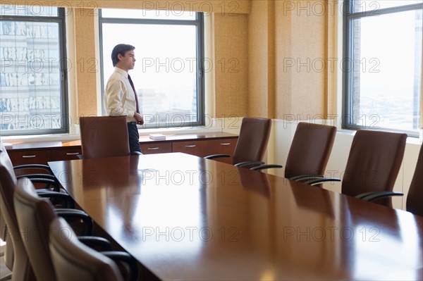 Businessman standing in board room.