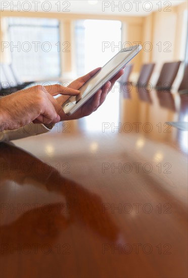 Hands of businessman using tablet pc.