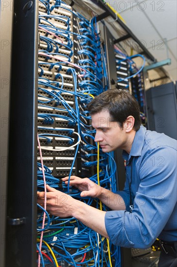 Technician inspecting network server.