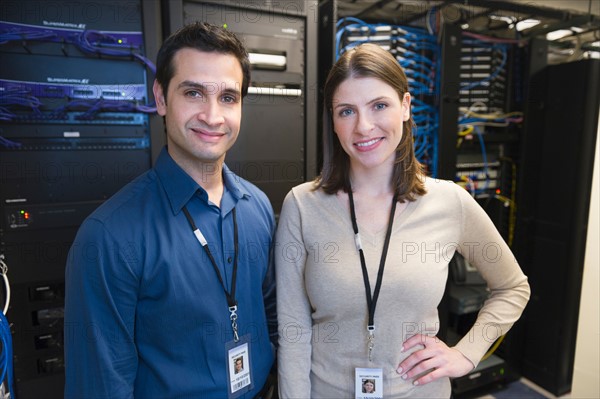 Portrait of technicians in network server room.