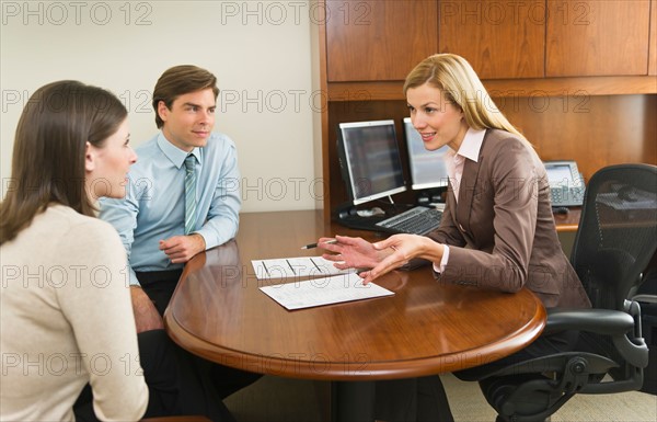 Businesswoman and clients talking in office.