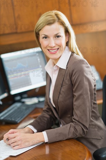 Portrait of businesswoman sitting at desk.