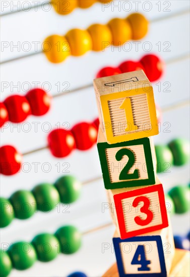 Studio shot of abacus and wooden blocks.