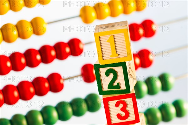 Studio shot of abacus and wooden blocks.