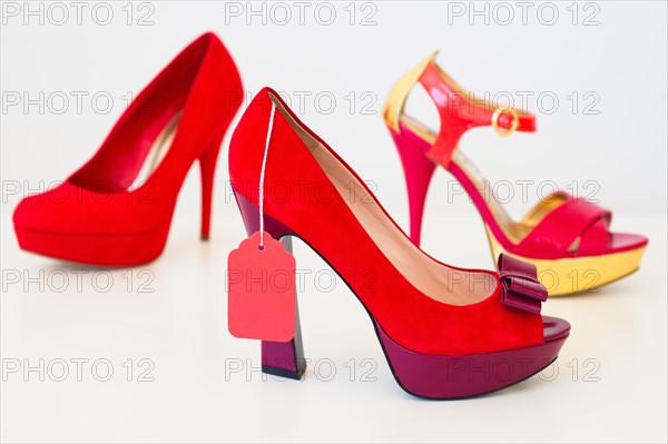 Red high heel shoes with price tag.